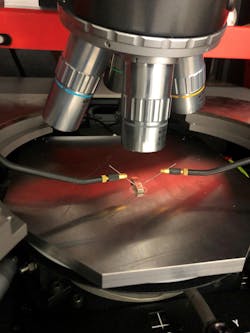 FIGURE 2. Tellurite glass with laser-written lines under testing via probe station. FIGURE 2. Tellurite glass with laser-written lines under testing via probe station.