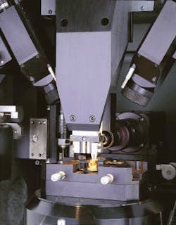Microwelding workstation uses pulsed 50-W Nd:YAG laser with multibeam fiberoptic-beam-delivery system to attach fiber to a 980-nm pump laser diode 'butterfly' package. Fiber is held in place by upper tweezers. Microwelding workstation uses pulsed 50-W Nd:YAG laser with multibeam fiberoptic-beam-delivery system to attach fiber to a 980-nm pump laser diode 'butterfly' package. Fiber is held in place by upper tweezers.