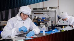 FIGURE 1. Vescent’s team in the cleanroom assembling frequency combs. FIGURE 1. Vescent’s team in the cleanroom assembling frequency combs.