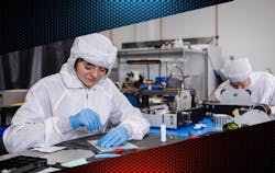 FIGURE 1. Vescent’s team in the cleanroom assembling frequency combs. FIGURE 1. Vescent’s team in the cleanroom assembling frequency combs.
