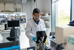 A scientist operating an atomic force microscope (AFM) used to measure properties of quantum dot films. A scientist operating an atomic force microscope (AFM) used to measure properties of quantum dot films.