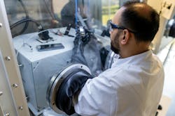 A scientist preparing a quantum-dot photodiode device for electrical measurement in a nitrogen-filled glove box. A scientist preparing a quantum-dot photodiode device for electrical measurement in a nitrogen-filled glove box.