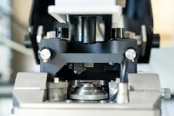 The head of an atomic force microscope (AFM) above a quantum dot film sample ready for measurement. The head of an atomic force microscope (AFM) above a quantum dot film sample ready for measurement.