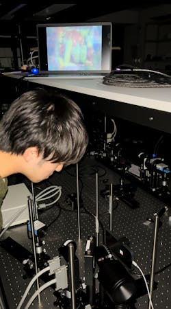 Otoya Shigematsu in the lab with the optical setup used for this work. Otoya Shigematsu in the lab with the optical setup used for this work.
