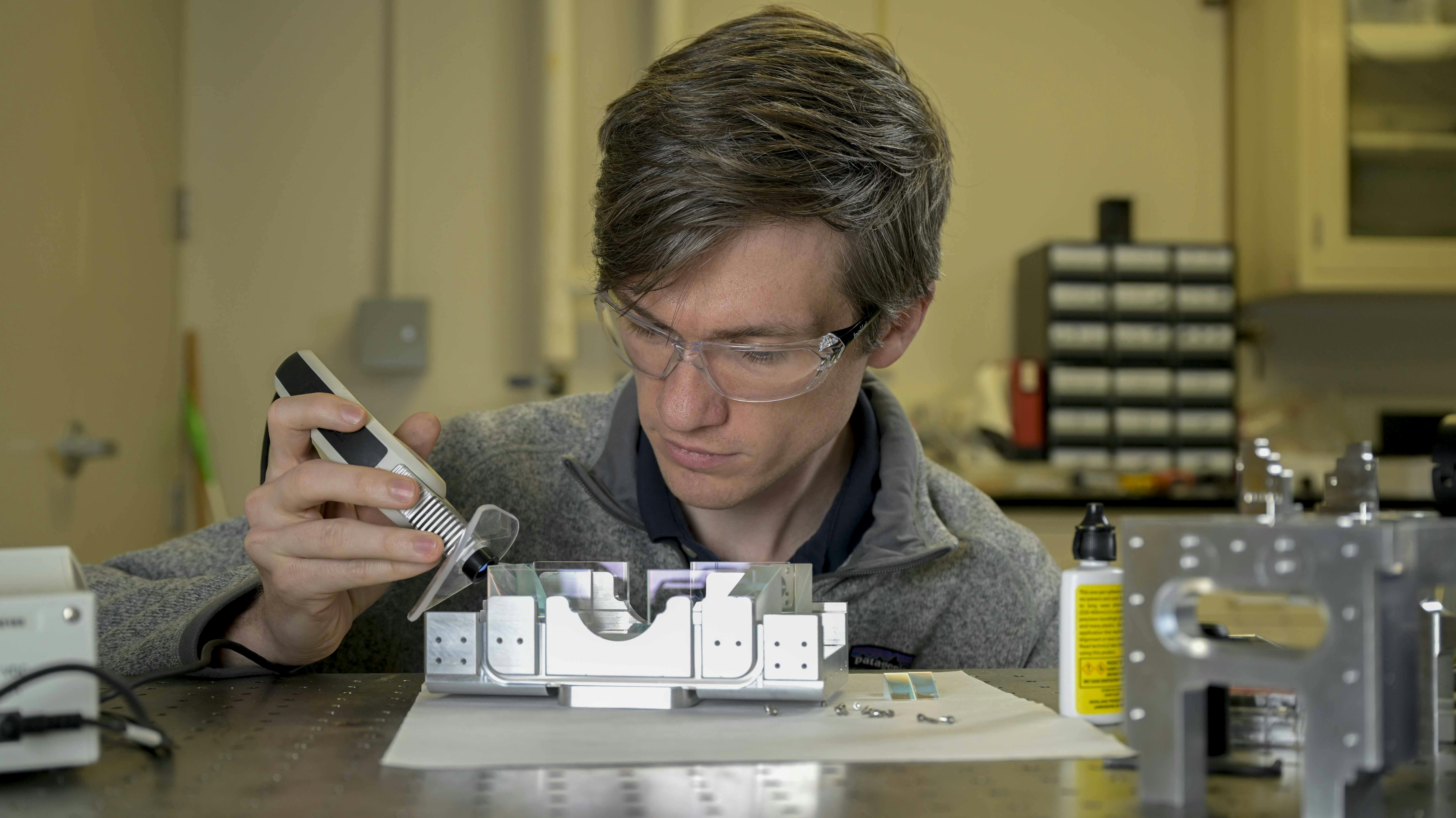 The cold, continuous atomic source used in the U.S. Naval Research Laboratory&rsquo;s continuous dual-beam interferometer program requires stable and well-aligned beams to cool and aim the atomic beam. In this photo, Jonathan Kwolek assembles the custom optical system to generate and aim each of the laser beams, which represents the first of multiple miniaturization efforts for compact and stable laser delivery in the NRL Atom Interferometry Lab.