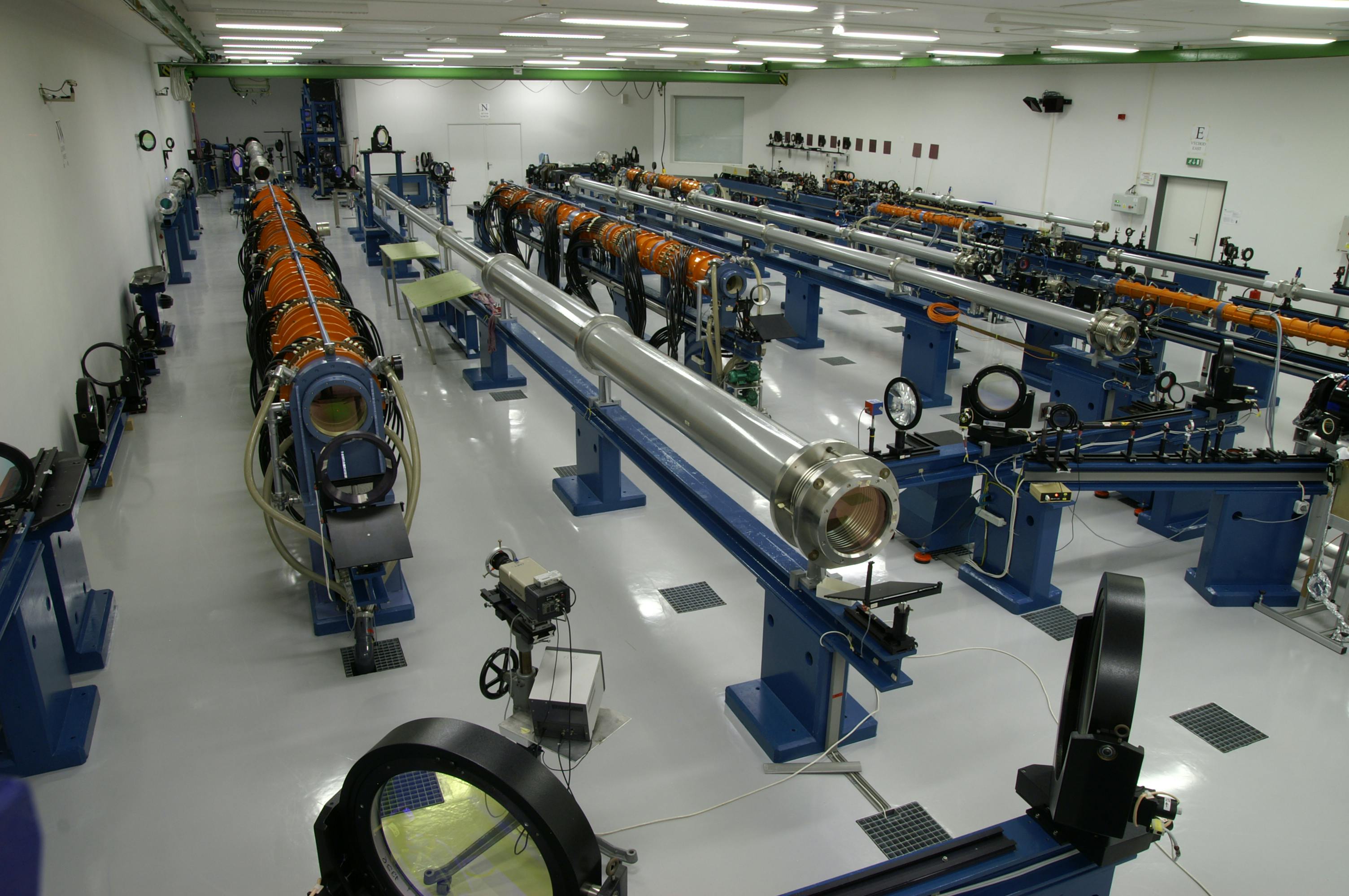 FIGURE 5. Overview photograph of the PALS laser system used in boron nitride target experiments; iodine photodissociation laser amplifiers are the orange tubes, while the silver-gray tubes are spatial filters.