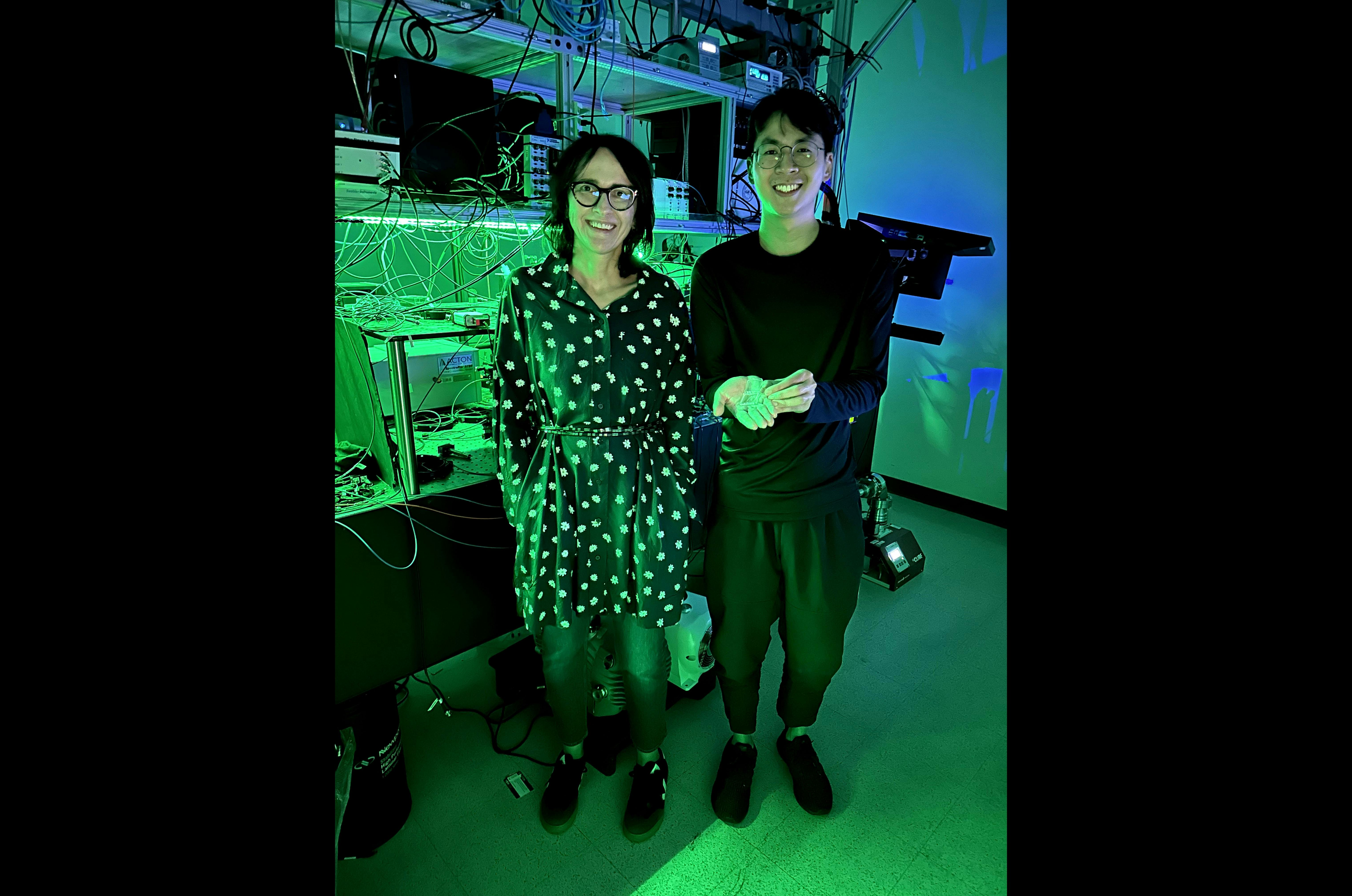 Jelena Vu&ccaron;kovi&cacute; and Joshua Yang in the lab&mdash;he&rsquo;s holding the laser and block of titanium-sapphire for scale.