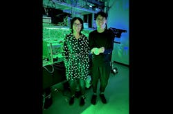 Jelena Vučković and Joshua Yang in the lab—he’s holding the laser and block of titanium-sapphire for scale. Jelena Vučković and Joshua Yang in the lab—he’s holding the laser and block of titanium-sapphire for scale.