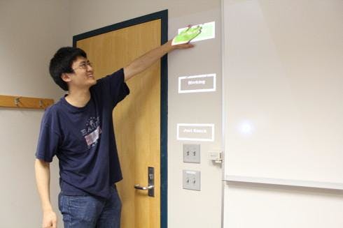 Carnegie Mellon University researchers are combining gesture control, cameras, and projectors to turn any surface into a touchscreen display simply through the wave of one&rsquo;s hand.