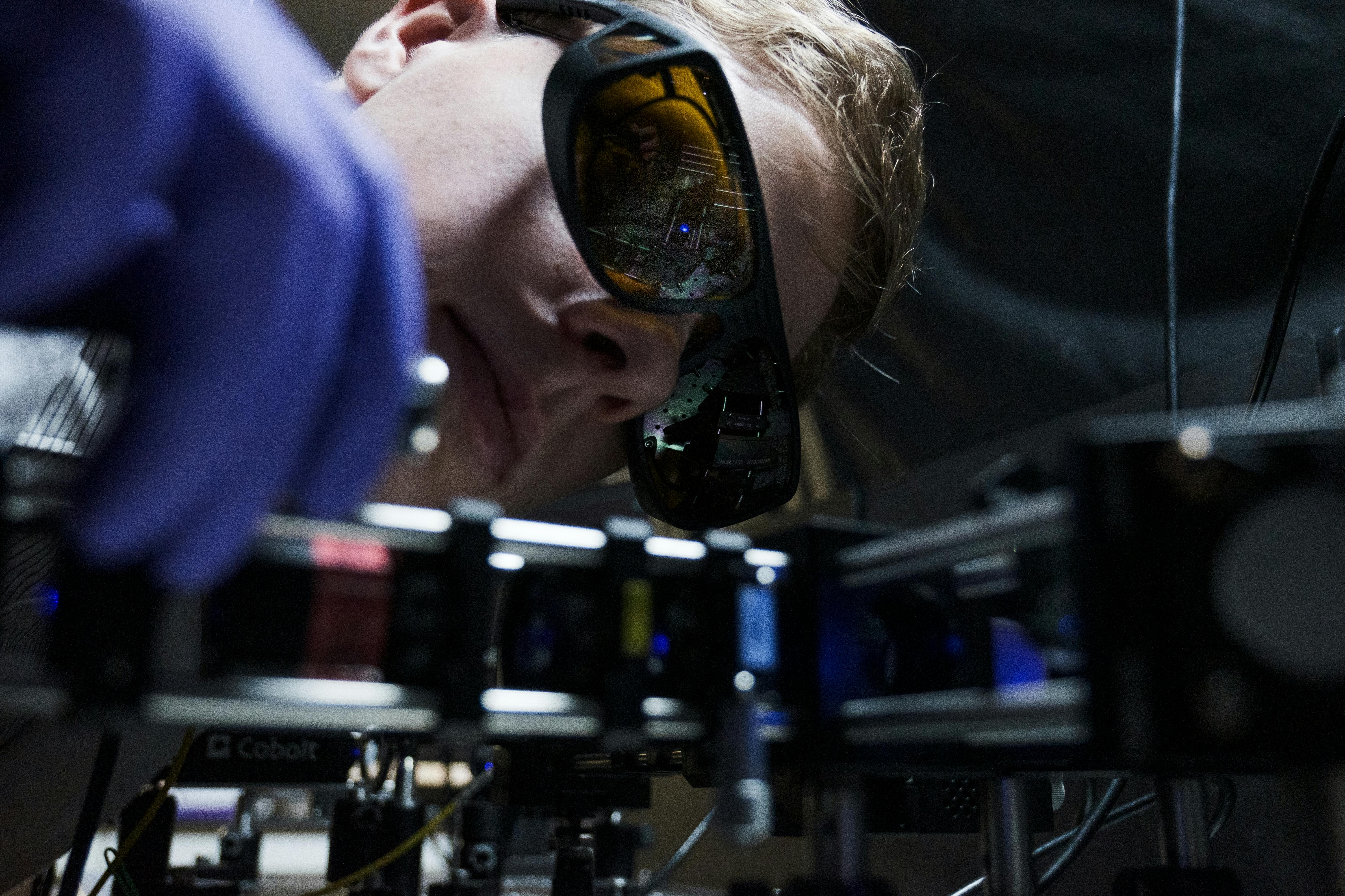 Ph.D. student Leevi Kallioniemi from NTU Singapore&rsquo;s School of Physical & Mathematical Sciences with a blue laser setup for generating entangled photon pairs.