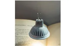 This light bulb is powered and held in place by two strands of carbon nanotube fibers that look and feel like textile thread. The nanotube fibers conduct heat and electricity as well as metal wires but are stronger and more flexible.