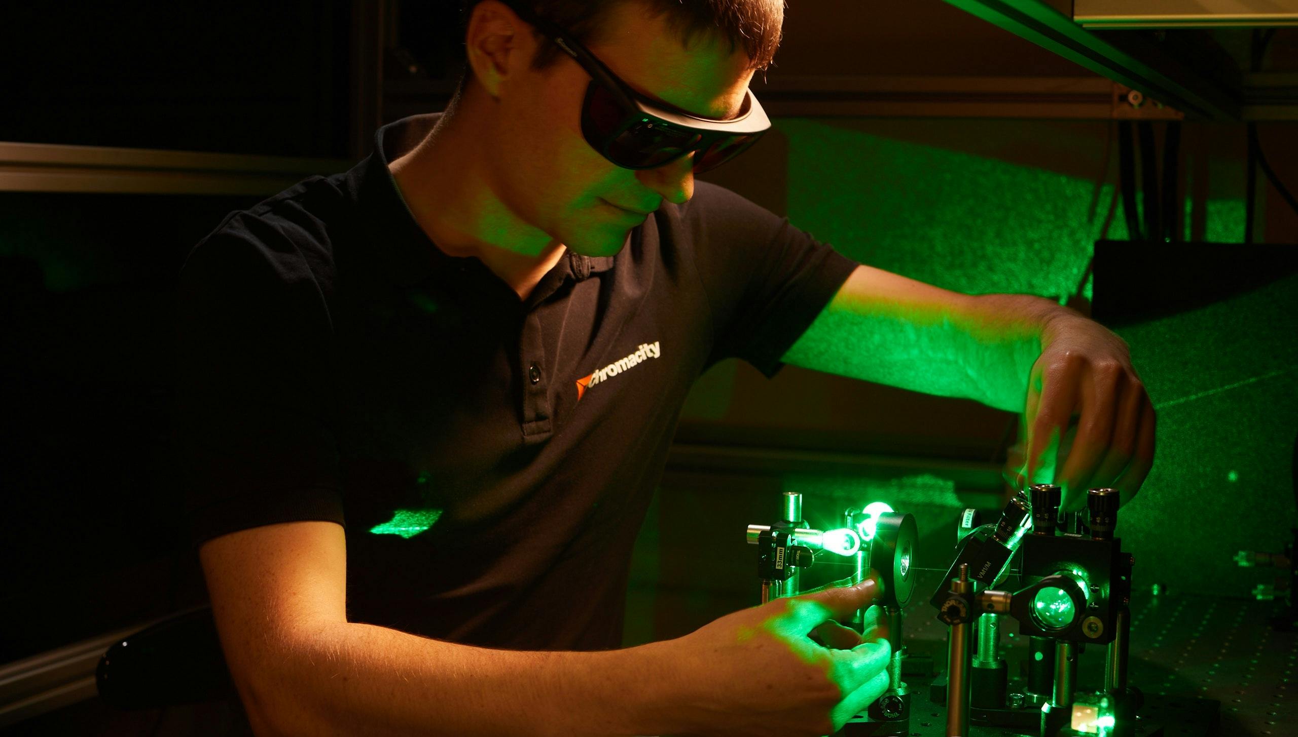 FIGURE 1. A Chromacity engineer aligns an ultrafast fiber laser with second-harmonic generation.