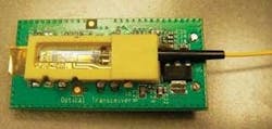 FIGURE 4. Because an integrated PLC-based transceiver (shown without lid) can be packaged to withstand shock and vibration, it can be used for aerospace applications running multiple wavelengths at 2.5 Gbit/s upstream and downstream. FIGURE 4. Because an integrated PLC-based transceiver (shown without lid) can be packaged to withstand shock and vibration, it can be used for aerospace applications running multiple wavelengths at 2.5 Gbit/s upstream and downstream.