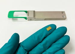 On the glove: A SCINTIL chip—a bank of 16 lasers monolithically integrated on a silicon photonic circuit and wavelength multiplexed. On the glove: A SCINTIL chip—a bank of 16 lasers monolithically integrated on a silicon photonic circuit and wavelength multiplexed.