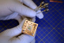 FIGURE 1. The new quantum refrigerator, visible as the square chip at the center of the copper enclosure, is built of superconducting qudits to cool a target superconducting qubit. FIGURE 1. The new quantum refrigerator, visible as the square chip at the center of the copper enclosure, is built of superconducting qudits to cool a target superconducting qubit.