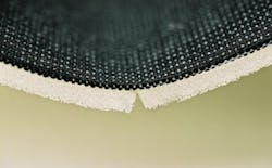 FIGURE 3. Airbag pre-weakening requires perforating the material with a series of blind holes, so that the cosmetics of the topmost layer are unaffected. FIGURE 3. Airbag pre-weakening requires perforating the material with a series of blind holes, so that the cosmetics of the topmost layer are unaffected.
