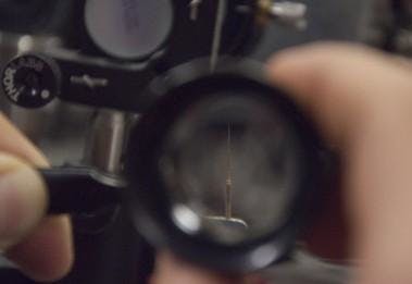 A silver-gallium nanowire serves as an AFM probe; its mechanical oscillations can be reduced via laser cooling.