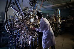 Sandia Materials Scientist Sadhvikas Addamane in the lab with a molecular beam epitaxy reactor, which is being used to build experimental photonic cooling plates designed by Maxwell Labs for testing at UNM. Credit: Craig Fritz/Sandia Sandia Materials Scientist Sadhvikas Addamane in the lab with a molecular beam epitaxy reactor, which is being used to build experimental photonic cooling plates designed by Maxwell Labs for testing at UNM. Credit: Craig Fritz/Sandia