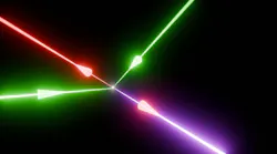 Photon-photon scattering effects within the lab: When two green petawatt lasers’ beams collide at the focus of a third red beam to polarize the quantum vacuum, it enables a fourth blue laser beam to be generated—with a unique direction and color. Credit: Zixin “Lily” Zhang