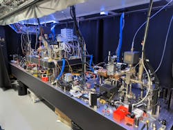 A table with equipment for containing three quantum entangled qubits at Duke University. A table with equipment for containing three quantum entangled qubits at Duke University.