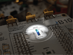 This packaged circuit board contains the chip placed under microscope in probe station during an experiment. Credit: BU This packaged circuit board contains the chip placed under microscope in probe station during an experiment. Credit: BU