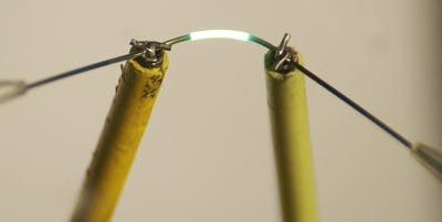 A fiber with a 500 nm diameter glows along a 5 mm length.
