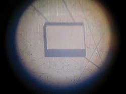 FIGURE 1. A rectangular 1 × 1 mm2 hole cut in 400 µm plastic sheet (nylon) by 266 nm, 4 ps pulses exhibits no obvious traces of residual carbon that typically develops as black areas covering the cut. Note that adding 1064 nm picosecond pulses causes carbon to appear and the quality of the cut deteriorates. Such peculiarities arise from the undesirable heating of the plastic by the 1064 nm pulses. FIGURE 1. A rectangular 1 × 1 mm2 hole cut in 400 µm plastic sheet (nylon) by 266 nm, 4 ps pulses exhibits no obvious traces of residual carbon that typically develops as black areas covering the cut. Note that adding 1064 nm picosecond pulses causes carbon to appear and the quality of the cut deteriorates. Such peculiarities arise from the undesirable heating of the plastic by the 1064 nm pulses.