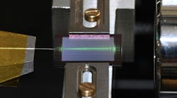 The team’s experimental setup uses an on-chip optical parametric oscillator (OPO) to generate a frequency comb of laser-like light over a wide range of frequencies. An optical fiber is to the left and a free-space objective is to the right. Credit: Alireza Marandi The team’s experimental setup uses an on-chip optical parametric oscillator (OPO) to generate a frequency comb of laser-like light over a wide range of frequencies. An optical fiber is to the left and a free-space objective is to the right. Credit: Alireza Marandi