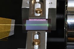 The team’s experimental setup uses an on-chip optical parametric oscillator (OPO) to generate a frequency comb of laser-like light over a wide range of frequencies. An optical fiber is to the left and a free-space objective is to the right. Credit: Alireza Marandi The team’s experimental setup uses an on-chip optical parametric oscillator (OPO) to generate a frequency comb of laser-like light over a wide range of frequencies. An optical fiber is to the left and a free-space objective is to the right. Credit: Alireza Marandi