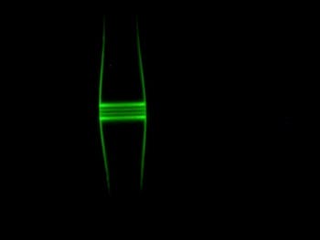 In a glass optical fiber, light is captured in a bulge in the fiber. It can't escape because the diameter of the fiber decreases on both sides.