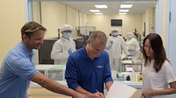 CEO of Mirrorcle Technologies, Dr. Veljko Milanovic singing the document alongside CFO of Mirrorcle Technologies, Peggie Lo, in front of our production clean room viewing area at our Headquarters in Richmond, CA.