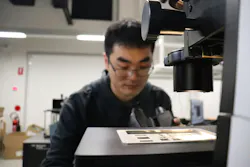 Chi Li examines a fabricated sample at the Monash Nanophotonics Laboratory. Chi Li examines a fabricated sample at the Monash Nanophotonics Laboratory.