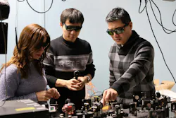 Dr. Ni and students working on an optical experiment in the lab. Dr. Ni and students working on an optical experiment in the lab.