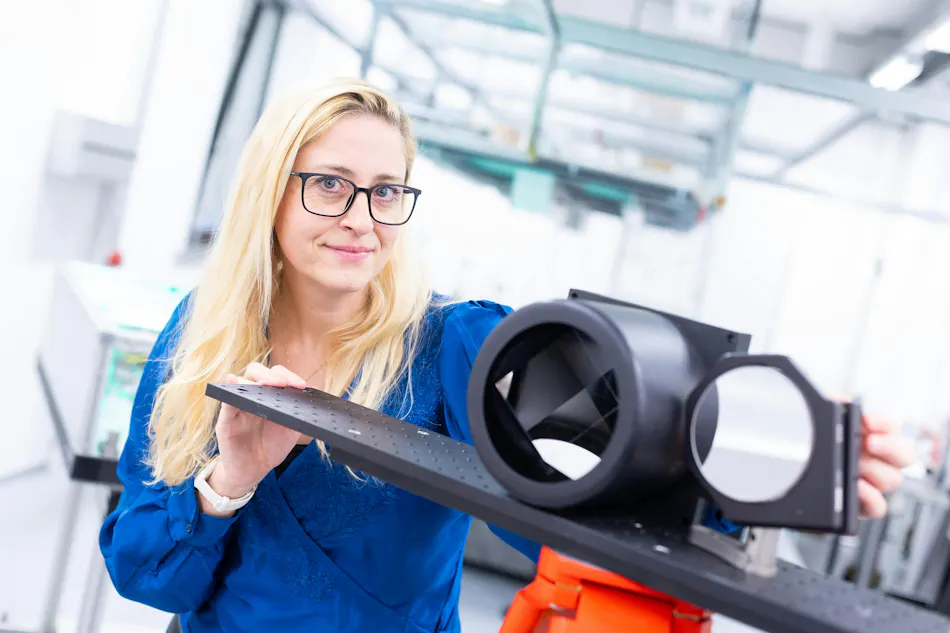 news-1-1 Birgitta Bernhardt in the lab with the retroreflector counterpart to her mobile UV dual-comb spectrometer.