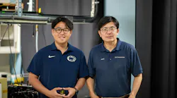 Yu-Jie Lin (left) holds the metalens the group developed, and Professor Zhiwen Liu is on his right.