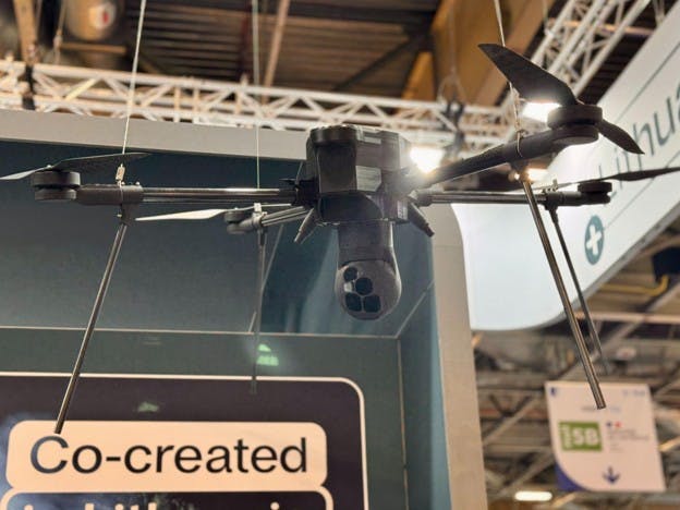 3D-printed plastic prototype of a payload mounted on a real-size drone, Eurosatory 2026 (Source: Tactical Photonics)