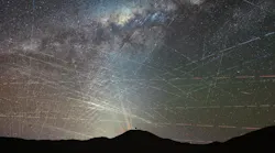 Satellites crossing the night sky above the northern Atacama Desert in Chile during an hour. It’s a stack of a time-lapse video taken on October 15, 2025, about two hours after sunset. Some streaks are caused by planes, easily identified by blinking-colored lights, but most trails are from satellites. In the foreground is the dome of ESO’s Extremely Large Telescope, the world’s largest optical/infrared telescope, currently under construction atop Cerro Armazones. Behind it are the lasers of ESO’s Very Large Telescope (VLT) at Paranal Observatory, 22 km away.