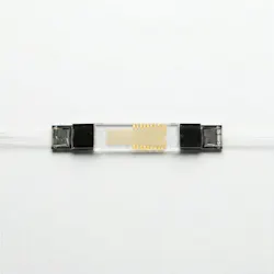 FIGURE 3. A fiber-pigtailed multichannel lithium-niobate waveguide chip manufactured at Exail’s Besançon facility.