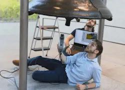 VAR Lab researchers work beneath the Liberty Bell with the Artec Eva, a handheld structured-light scanner, to capture difficult-to-reach geometry around its underside and internal support structure while monitoring scan data onsite.