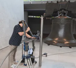 A VAR Lab researcher uses a FARO Quantum X FaroArm with a Blu laser line probe to capture high-resolution surface geometry of the Liberty Bell without touching the artifact.